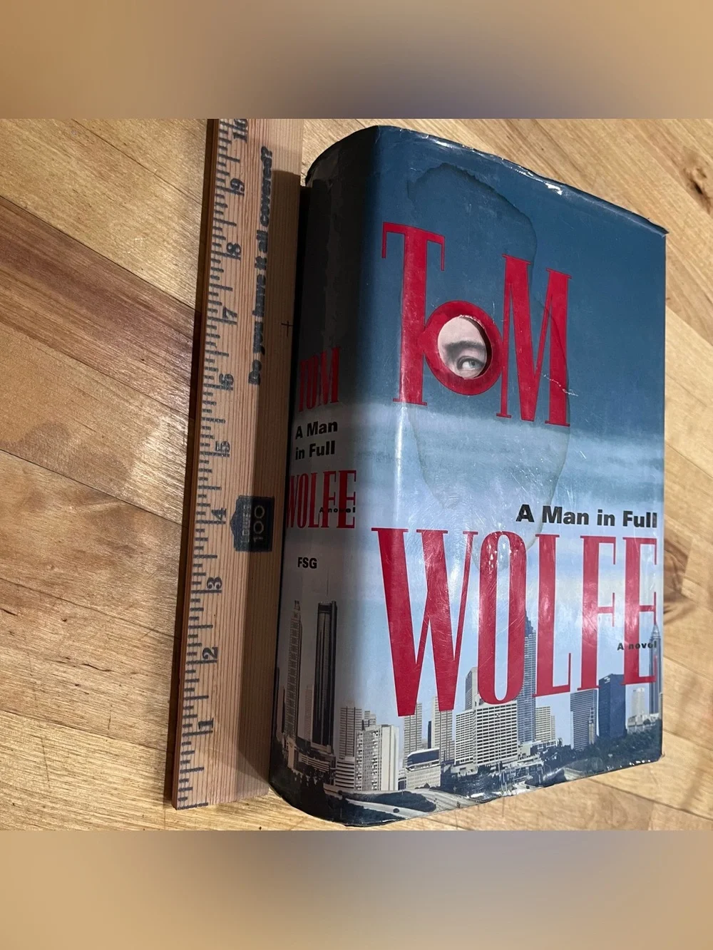 Tom Wolfe FIRST TRADE EDITION HC 1998. Damaged dust cover. Good Spine.